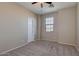 This bedroom features neutral walls and carpet, complemented by a ceiling fan and a window at 15105 W Glenrosa Ave, Goodyear, AZ 85395