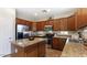 Well-equipped kitchen featuring stainless steel appliances, granite countertops, and wooden cabinets at 15105 W Glenrosa Ave, Goodyear, AZ 85395