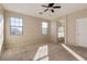Spacious main bedroom with neutral carpet, ensuite bathroom access, and sunny windows at 15105 W Glenrosa Ave, Goodyear, AZ 85395