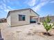 Backyard with covered patio featuring a blue cushioned sofa and gravel landscaping with young trees planted at 15817 S 177Th Dr, Goodyear, AZ 85338