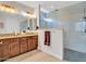 Bathroom boasts double sink vanity with granite countertops and a modern glass-enclosed shower at 15817 S 177Th Dr, Goodyear, AZ 85338