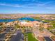 Aerial view of the community center near a lake, golf course, and parking lot at 15817 S 177Th Dr, Goodyear, AZ 85338