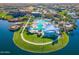 Aerial view of a community pool and island covered by a sunshade next to a lake at 15817 S 177Th Dr, Goodyear, AZ 85338