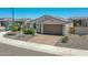 Charming single-story home boasts a paver driveway, a 2-car garage, and low maintenance desert landscaping at 15817 S 177Th Dr, Goodyear, AZ 85338