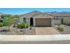 Charming single-story home boasts a paver driveway, a 2-car garage, and low maintenance desert landscaping at 15817 S 177Th Dr, Goodyear, AZ 85338