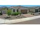 Charming single-story home boasts a paver driveway, a 2-car garage, and low maintenance desert landscaping at 15817 S 177Th Dr, Goodyear, AZ 85338