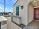 Stylish exterior with a cozy bench, lantern fixture, brick pathway and arched entry door at 15817 S 177Th Dr, Goodyear, AZ 85338