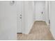 Bright hallway with wood look flooring and white walls leading to other rooms at 15817 S 177Th Dr, Goodyear, AZ 85338