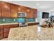 Kitchen with granite countertops, mosaic backsplash, stainless steel appliances, and wood cabinetry at 15817 S 177Th Dr, Goodyear, AZ 85338