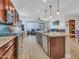 Spacious kitchen featuring a large island, stainless steel appliances, and seamless flow into the living area at 15817 S 177Th Dr, Goodyear, AZ 85338