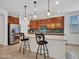 Stylish kitchen featuring granite counters, dark cabinets, island seating and pendant lights at 15817 S 177Th Dr, Goodyear, AZ 85338