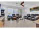 Comfortable living room featuring leather seating, tile floors, a ceiling fan and a glass coffee table at 15817 S 177Th Dr, Goodyear, AZ 85338