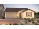 Charming single-story home with a two-car garage and desert landscaping in the front yard at 16446 W Whispering Wind Dr, Surprise, AZ 85387