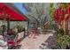 Backyard retreat with ample seating, mature trees, interesting plants and unique decorations at 1702 W Monterosa W St, Phoenix, AZ 85015