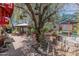 Extensive backyard with brick-paved surface, outdoor decor and a mature shade tree at 1702 W Monterosa W St, Phoenix, AZ 85015