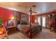 A primary bedroom featuring a four-poster bed, an ensuite, and large windows with custom drapes at 1702 W Monterosa W St, Phoenix, AZ 85015