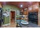 A kitchen area showcasing stainless steel appliances, custom cabinetry, and a striking glass-top island with seating at 1702 W Monterosa W St, Phoenix, AZ 85015