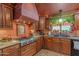 A gourmet kitchen featuring a professional Viking stovetop, custom cabinets, and copper accents at 1702 W Monterosa W St, Phoenix, AZ 85015