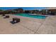 Community pool and surrounding amenity area with picnic tables, shade structures, and lounge seating at 17373 W Jessie Ln, Surprise, AZ 85387
