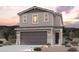 Inviting two-story home featuring a neutral color palette, a two car garage, and desert landscaping at 17373 W Jessie Ln, Surprise, AZ 85387