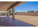 Covered patio that overlooks the gravel-filled backyard at 17844 W Caribbean Ln, Surprise, AZ 85388