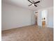 Open bedroom area featuring tile floors and entrances to en-suite bathroom and closet at 17844 W Caribbean Ln, Surprise, AZ 85388