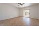 Spacious bedroom featuring tile floors, ceiling fan, and sliding glass doors to the backyard at 17844 W Caribbean Ln, Surprise, AZ 85388
