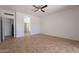 Large bedroom featuring tile floors and an arched entrance to the en-suite bathroom at 17844 W Caribbean Ln, Surprise, AZ 85388