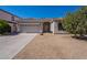 Charming single-story home featuring a low maintenance desert landscape and a two-car garage at 17844 W Caribbean Ln, Surprise, AZ 85388