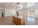 Spacious kitchen island with wood cabinets and large sliding glass doors to the backyard at 17844 W Caribbean Ln, Surprise, AZ 85388