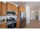 Updated kitchen featuring stainless steel appliances and plenty of cabinet space with modern fixtures at 17844 W Caribbean Ln, Surprise, AZ 85388