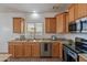 View of the kitchen area with updated appliances, lots of counter space, and wood cabinetry at 17844 W Caribbean Ln, Surprise, AZ 85388