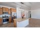 Open-concept kitchen featuring an island with stone countertops and stainless steel appliances at 17844 W Caribbean Ln, Surprise, AZ 85388