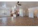 Spacious open-concept living area with adjacent kitchen and large tile flooring at 17844 W Caribbean Ln, Surprise, AZ 85388