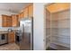 View of a kitchen and pantry area with an array of shelving to store food items at 17844 W Caribbean Ln, Surprise, AZ 85388