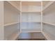 Walk-in pantry with ample shelving offering generous storage space for all your groceries and essentials at 17844 W Caribbean Ln, Surprise, AZ 85388