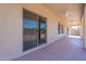 A covered patio with ceiling fans and a sliding glass door at 17844 W Caribbean Ln, Surprise, AZ 85388