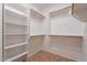 Walk-in closet featuring multiple wooden rods and shelving for ample storage at 17844 W Caribbean Ln, Surprise, AZ 85388