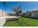 Expansive grassy backyard featuring a concrete patio and comfortable outdoor living space at 18233 N 55Th Dr, Glendale, AZ 85308