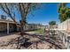 Backyard showcasing brick patio, shade tree, grassy area and outdoor living at 18233 N 55Th Dr, Glendale, AZ 85308
