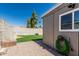 Spacious fenced backyard with green grass and a hose by the shed at 18233 N 55Th Dr, Glendale, AZ 85308