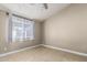 Neutral bedroom featuring a ceiling fan, tile flooring, and a window at 18233 N 55Th Dr, Glendale, AZ 85308