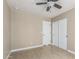 A well lit bedroom with a ceiling fan, tiled floor and neutral color pallete at 18233 N 55Th Dr, Glendale, AZ 85308