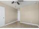 A well lit bedroom with a ceiling fan, tiled floor and neutral color pallete at 18233 N 55Th Dr, Glendale, AZ 85308