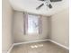 A naturally lit bedroom with a ceiling fan, tiled floor and neutral color pallete at 18233 N 55Th Dr, Glendale, AZ 85308