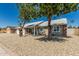 Quaint single-story home with mature shade trees, appealing front yard, and a blue front door at 18233 N 55Th Dr, Glendale, AZ 85308
