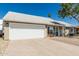 Inviting single-story home with a two-car garage, appealing front yard, and a blue front door at 18233 N 55Th Dr, Glendale, AZ 85308