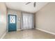 Bright foyer with a vaulted ceiling, tile flooring, and a blue front door with diamond window panes at 18233 N 55Th Dr, Glendale, AZ 85308