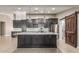 Modern kitchen with stainless steel appliances, a large island, and dark wood cabinets at 18233 N 55Th Dr, Glendale, AZ 85308