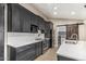 Well-equipped kitchen featuring stainless steel appliances, dark wood cabinets, and a stylish barn door at 18233 N 55Th Dr, Glendale, AZ 85308